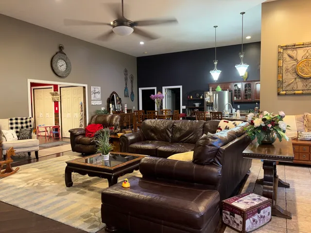 a living room with furniture a clock and a window