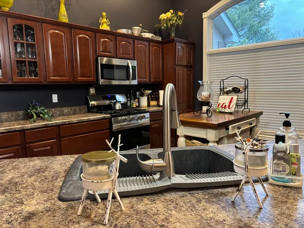 a kitchen view with dining table and chairs
