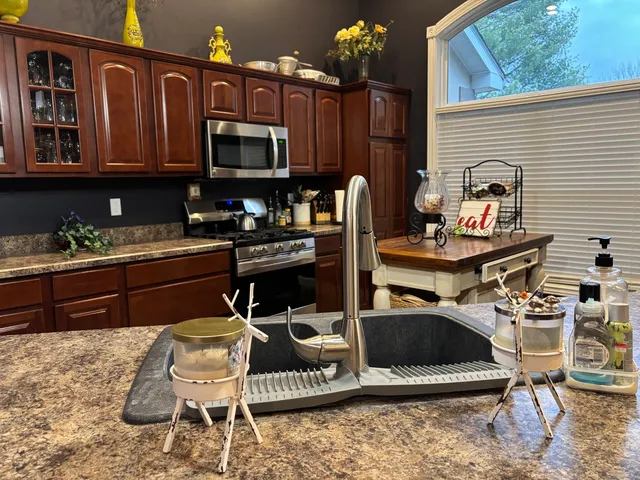 a kitchen view with dining table and chairs
