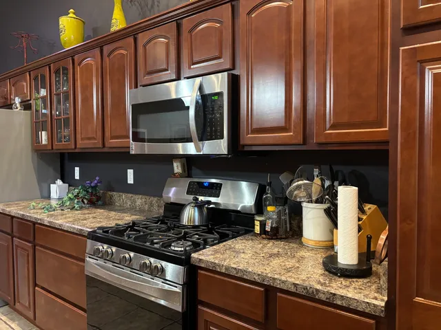 a kitchen with granite countertop stainless steel appliances and cabinets