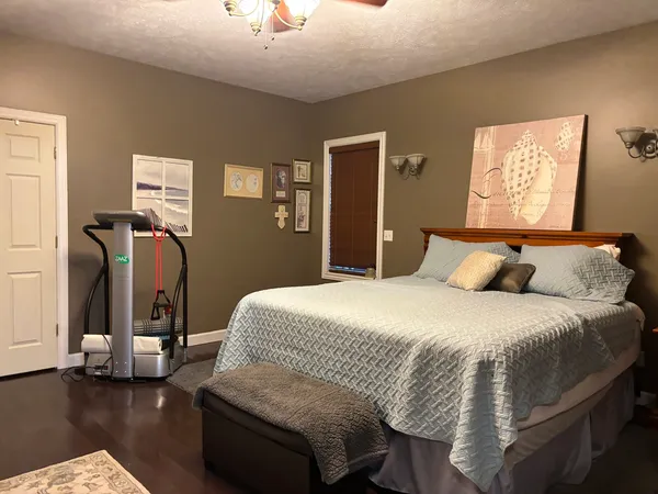 a bedroom with bed and wooden floor