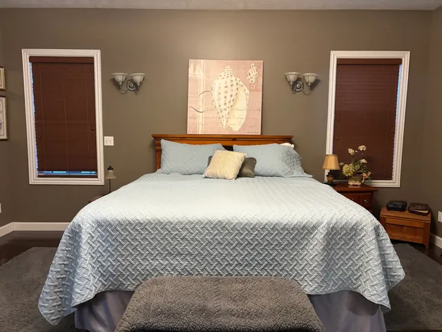 a bedroom with a bed and window