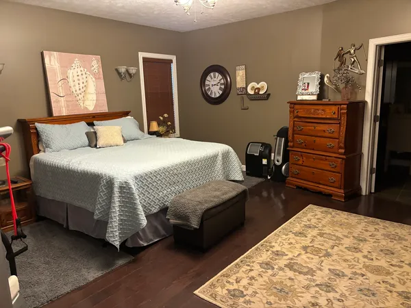 a bedroom with a bed and a dresser in it