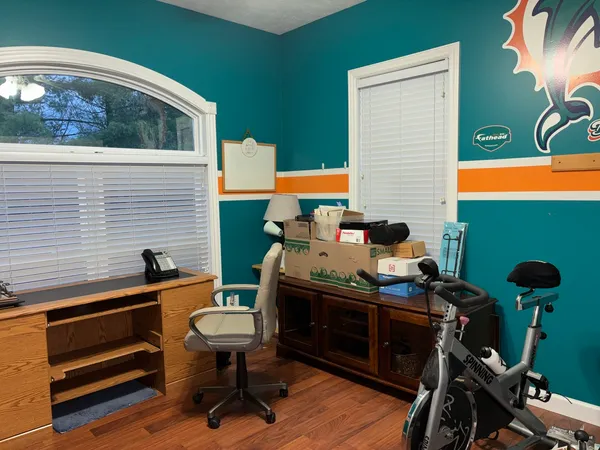 a reading room with furniture and wooden floor