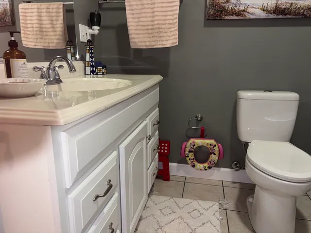 a bathroom with a toilet a sink and a mirror