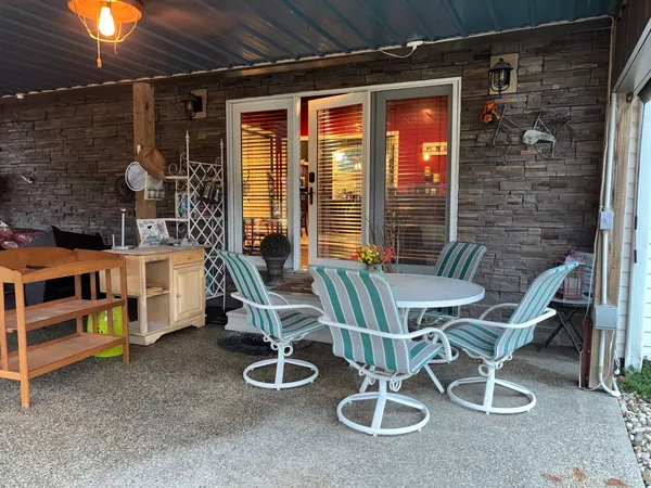 a balcony with table and chairs