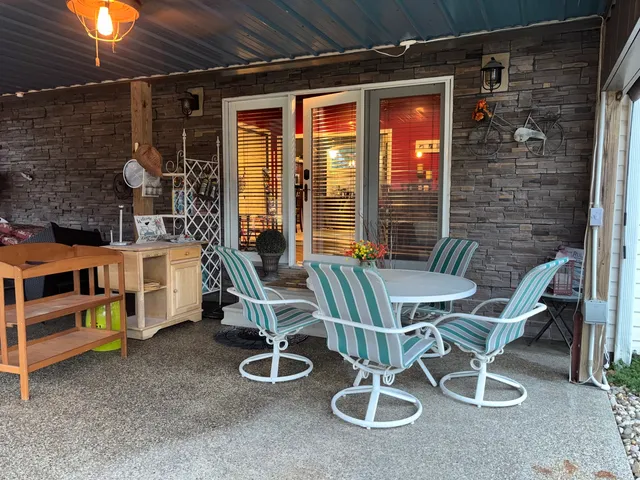 a balcony with table and chairs
