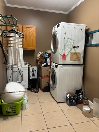 a utility room with a washing machine and a fireplace