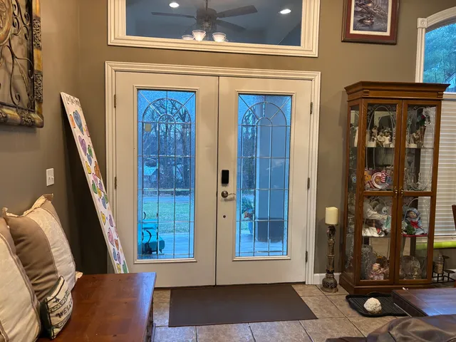 a view of front door with furniture and a rug