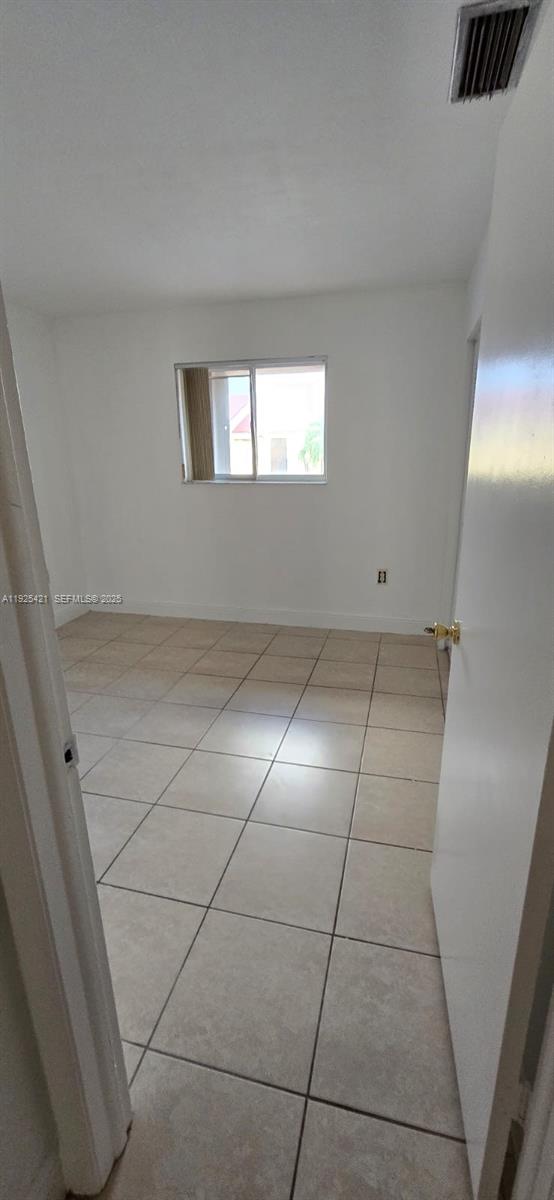 560 Northwest 82nd Place, Unit 303 Miami, FL 33126 - Photo 5 of 10 a view of a livingroom with an empty space and window