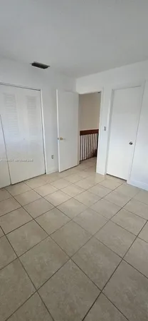 a view of an empty room and garage