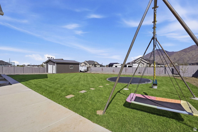 572 West 500th Street North Mapleton, UT 84664 - Photo 39 of 46 Fenced backyard featuring an outbuilding, a trampoline, a mountain view, and a residential view