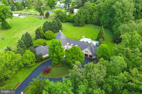 an aerial view of a residential houses with outdoor space and street view