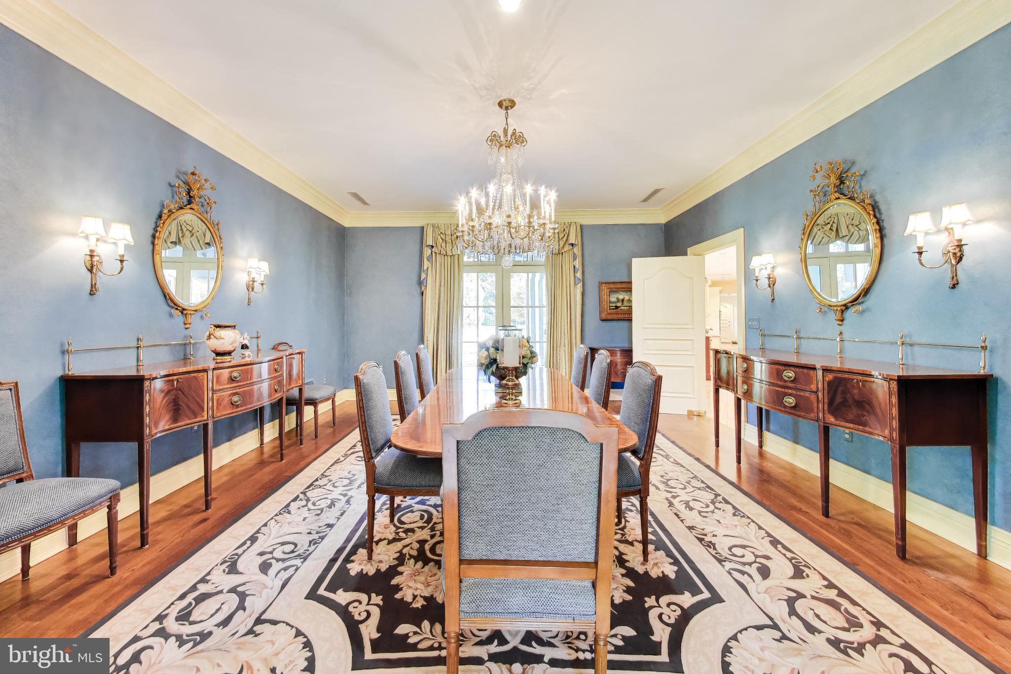 9001 Persimmon Tree Road Potomac, MD 20854 - Photo 11 of 77 a view of a dining room with furniture a chandelier and wooden floor