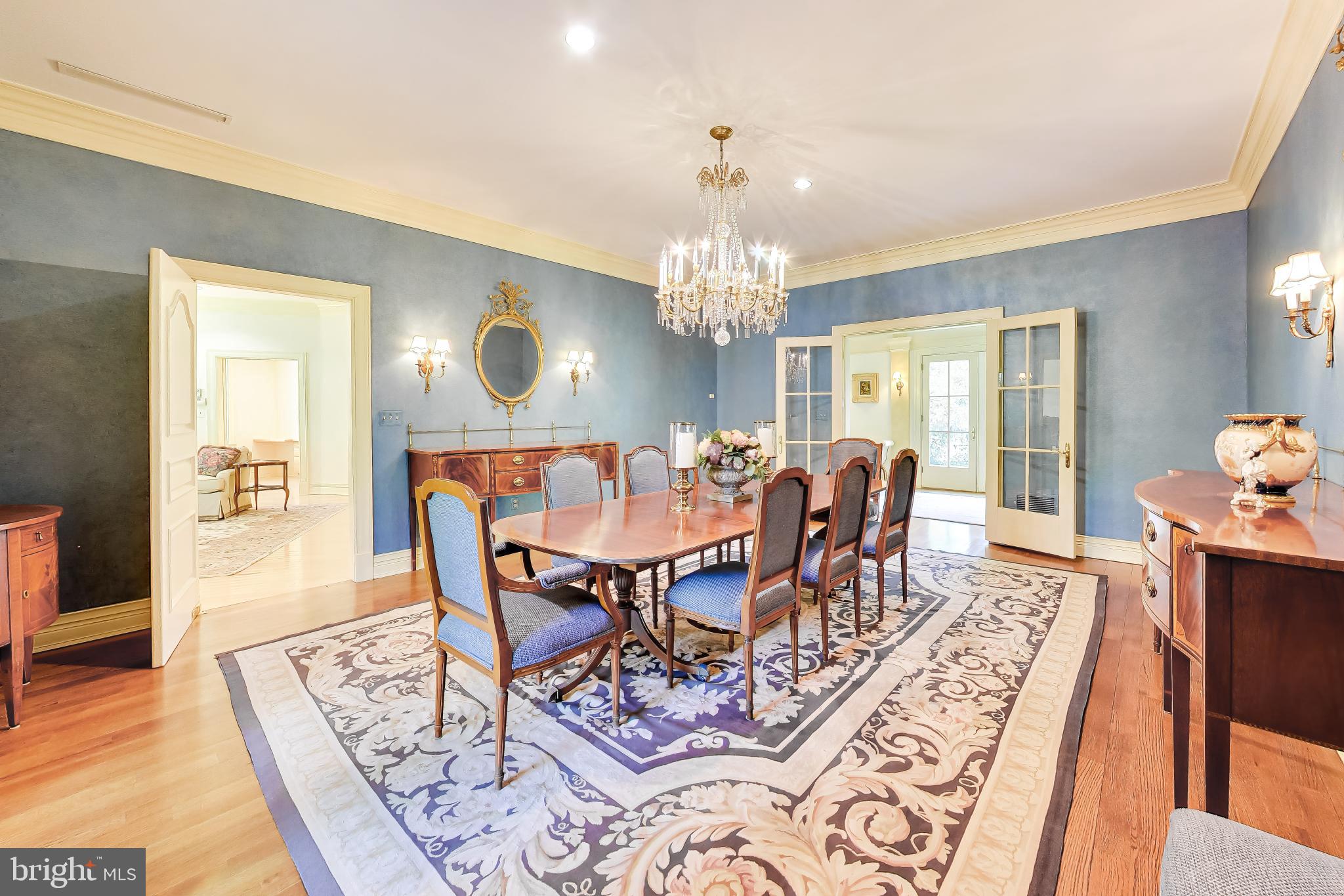 9001 Persimmon Tree Road Potomac, MD 20854 - Photo 12 of 77 a view of a dining room with furniture and chandelier