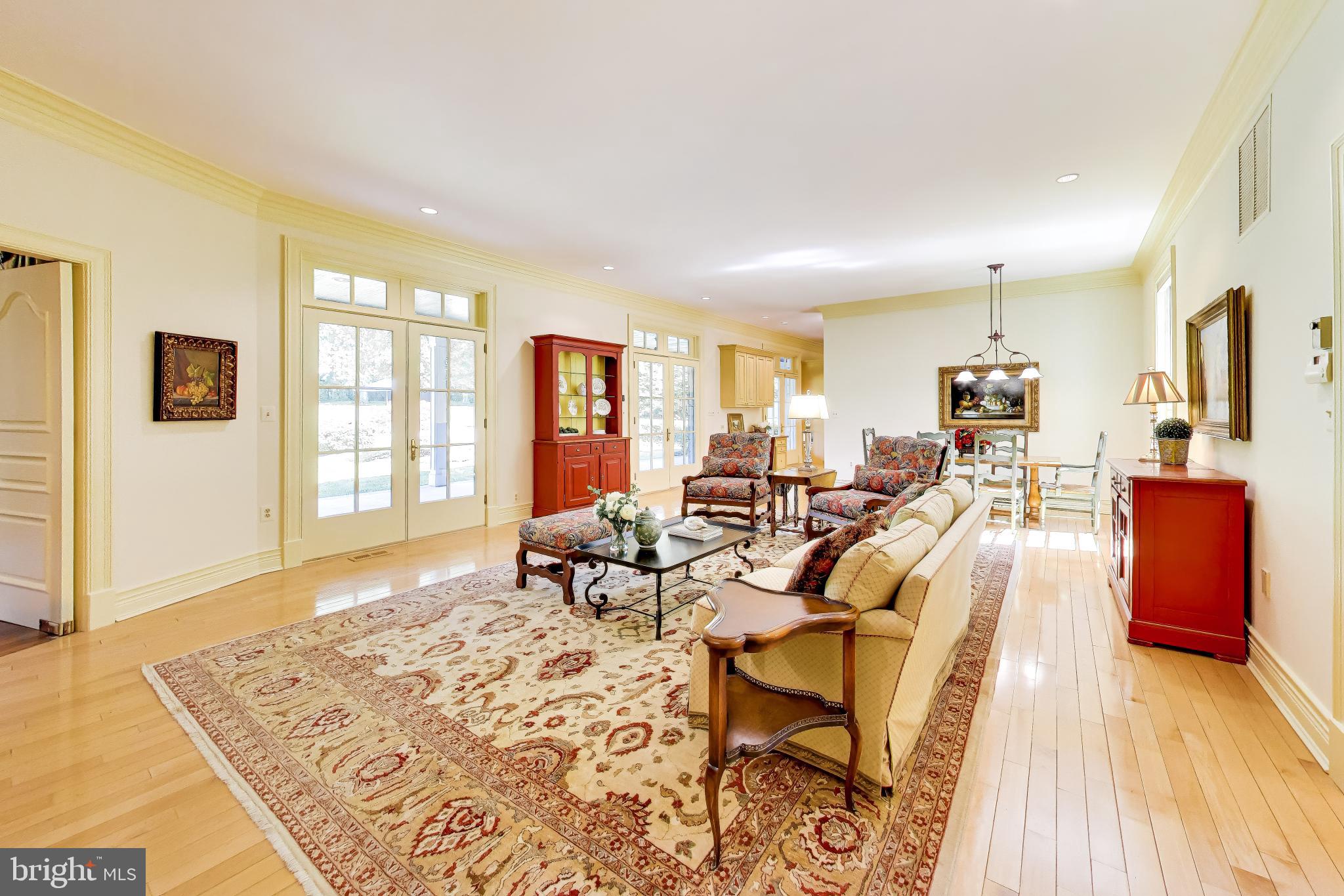 9001 Persimmon Tree Road Potomac, MD 20854 - Photo 19 of 77 a living room with furniture and a table