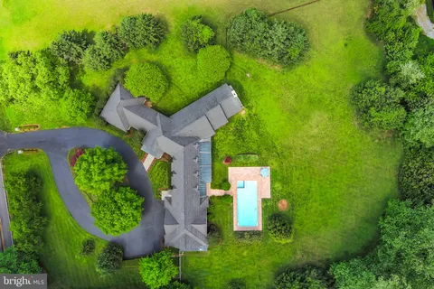 an aerial view of a house with a yard