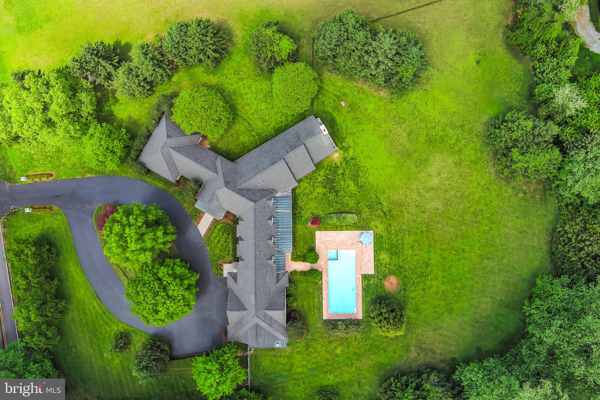 9001 Persimmon Tree Road Potomac, MD 20854 - Photo 2 of 77 an aerial view of a house with a yard basket ball court and outdoor seating