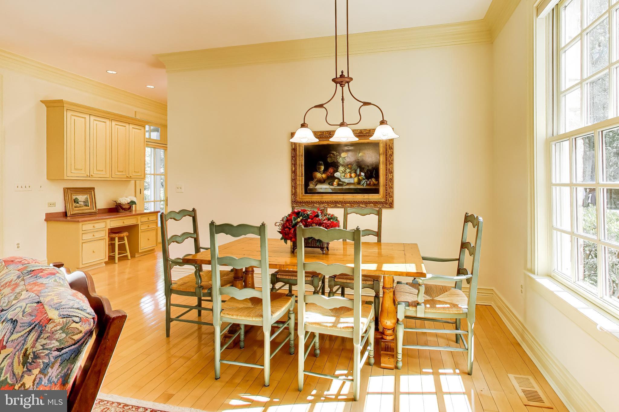 9001 Persimmon Tree Road Potomac, MD 20854 - Photo 22 of 77 a view of a dining room with furniture a chandelier and a window