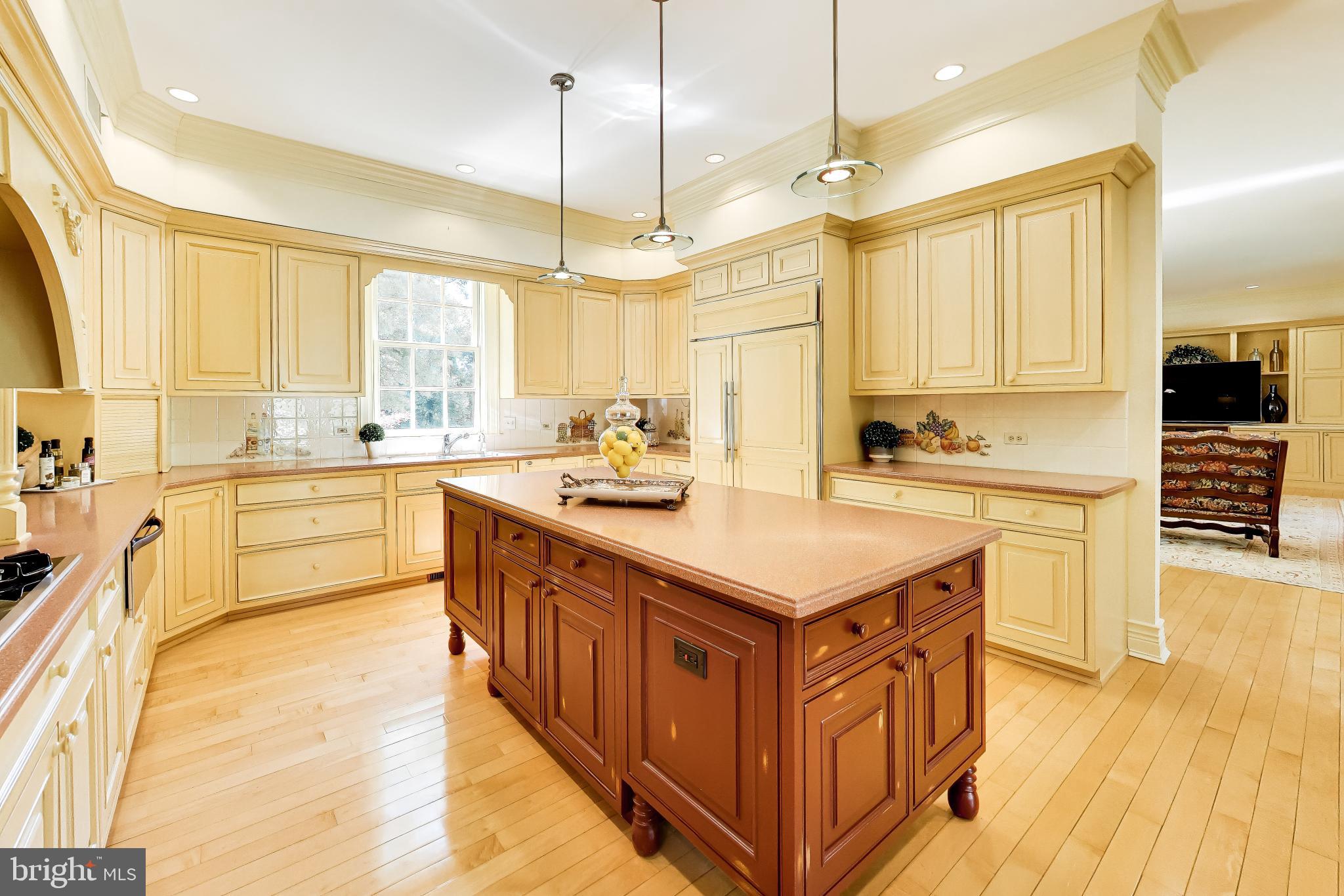 9001 Persimmon Tree Road Potomac, MD 20854 - Photo 26 of 77 a kitchen with a stove a sink a center island and a window