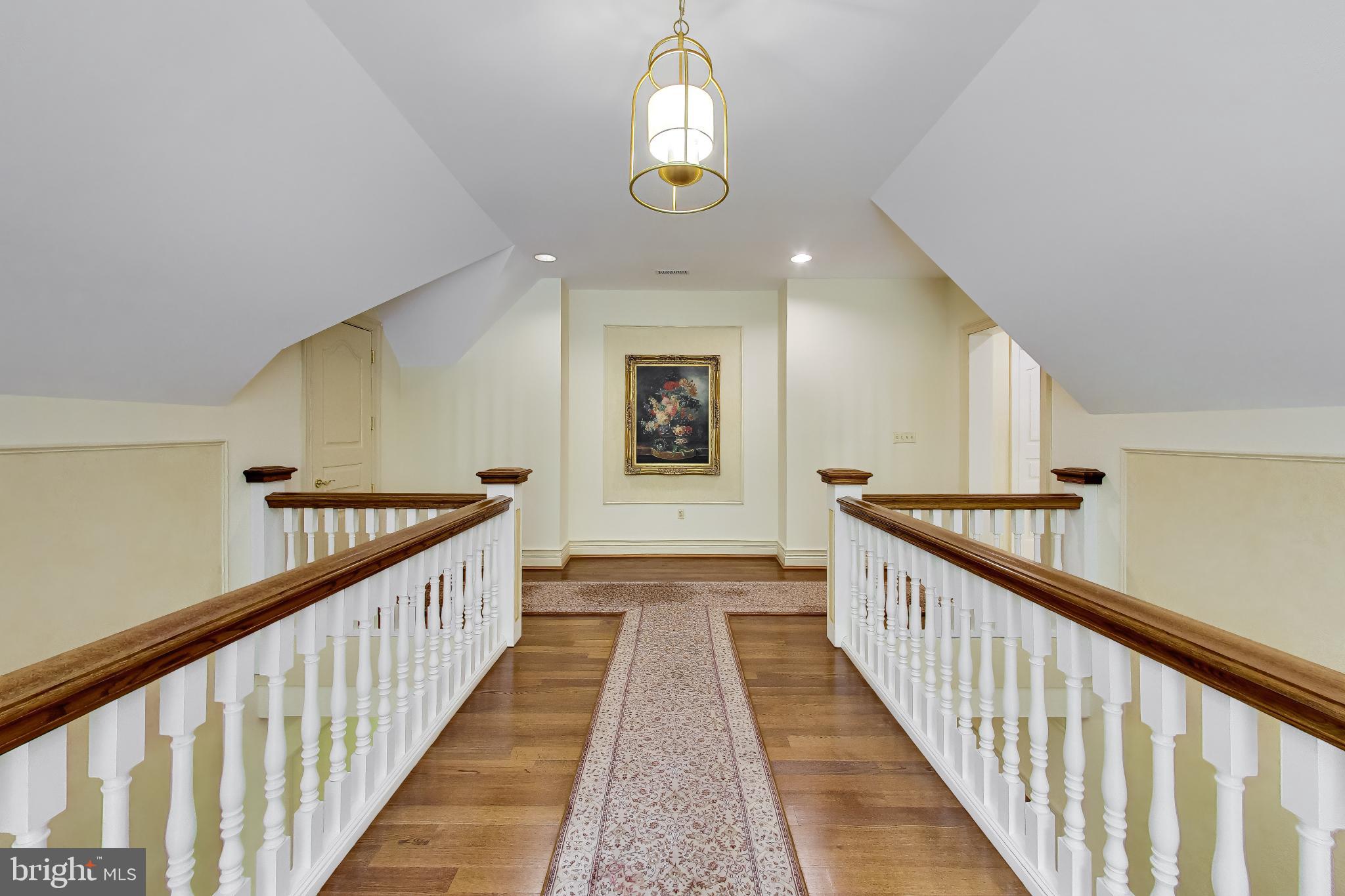 9001 Persimmon Tree Road Potomac, MD 20854 - Photo 37 of 77 a view of a hallway view with wooden floor and staircase