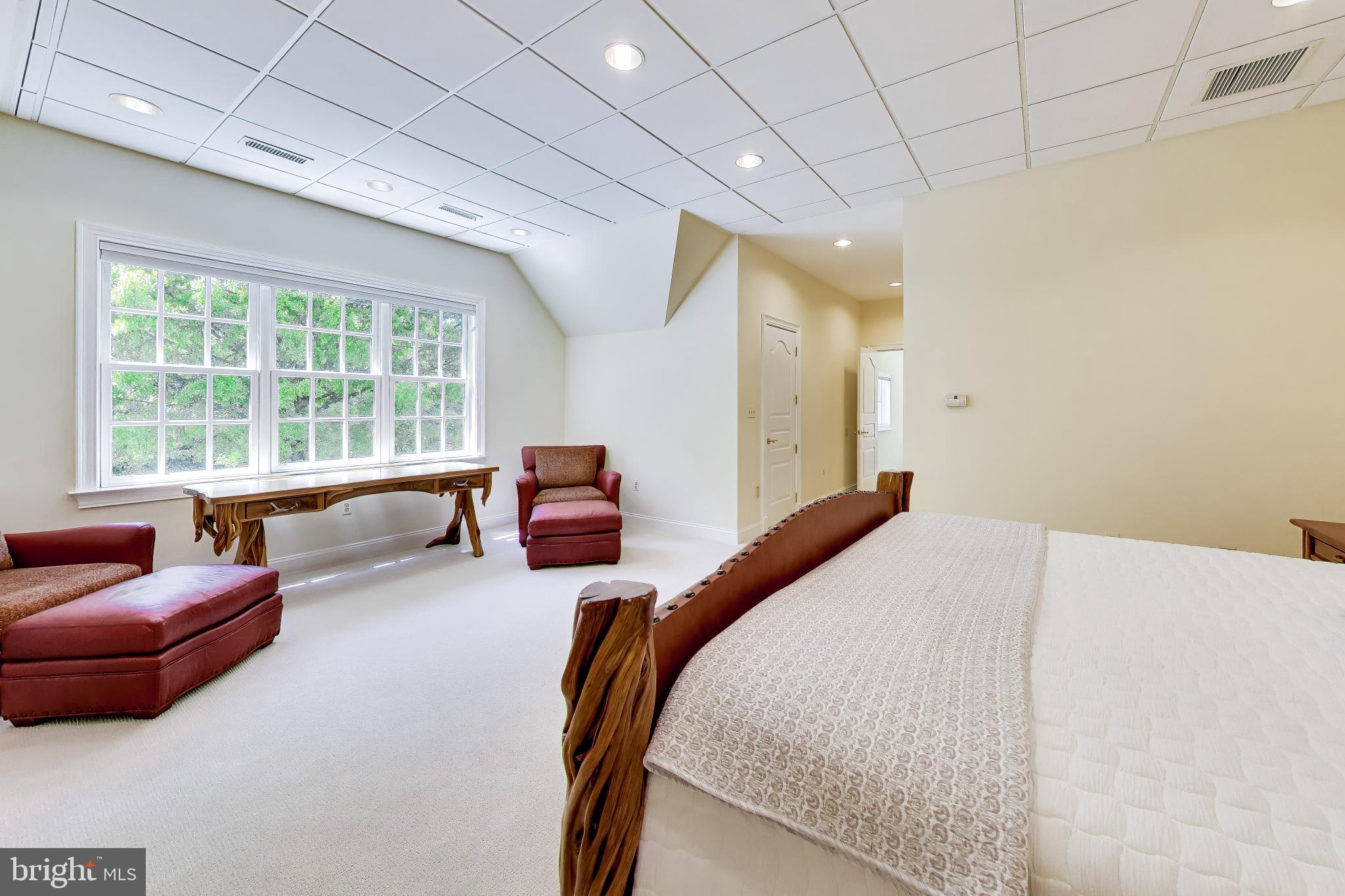 9001 Persimmon Tree Road Potomac, MD 20854 - Photo 46 of 77 a bedroom with a bed couch and window