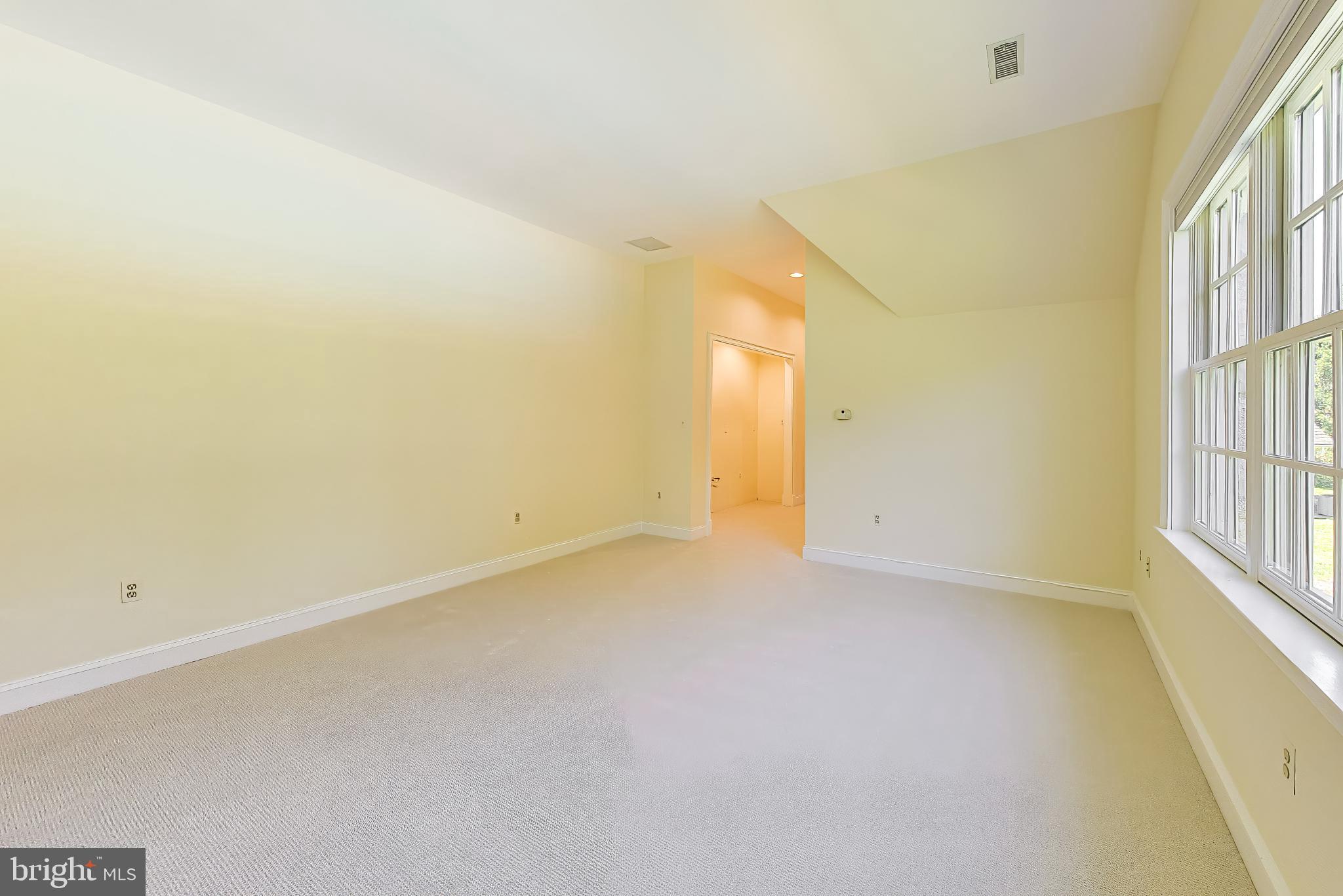 9001 Persimmon Tree Road Potomac, MD 20854 - Photo 50 of 77 a view of an empty room with a window