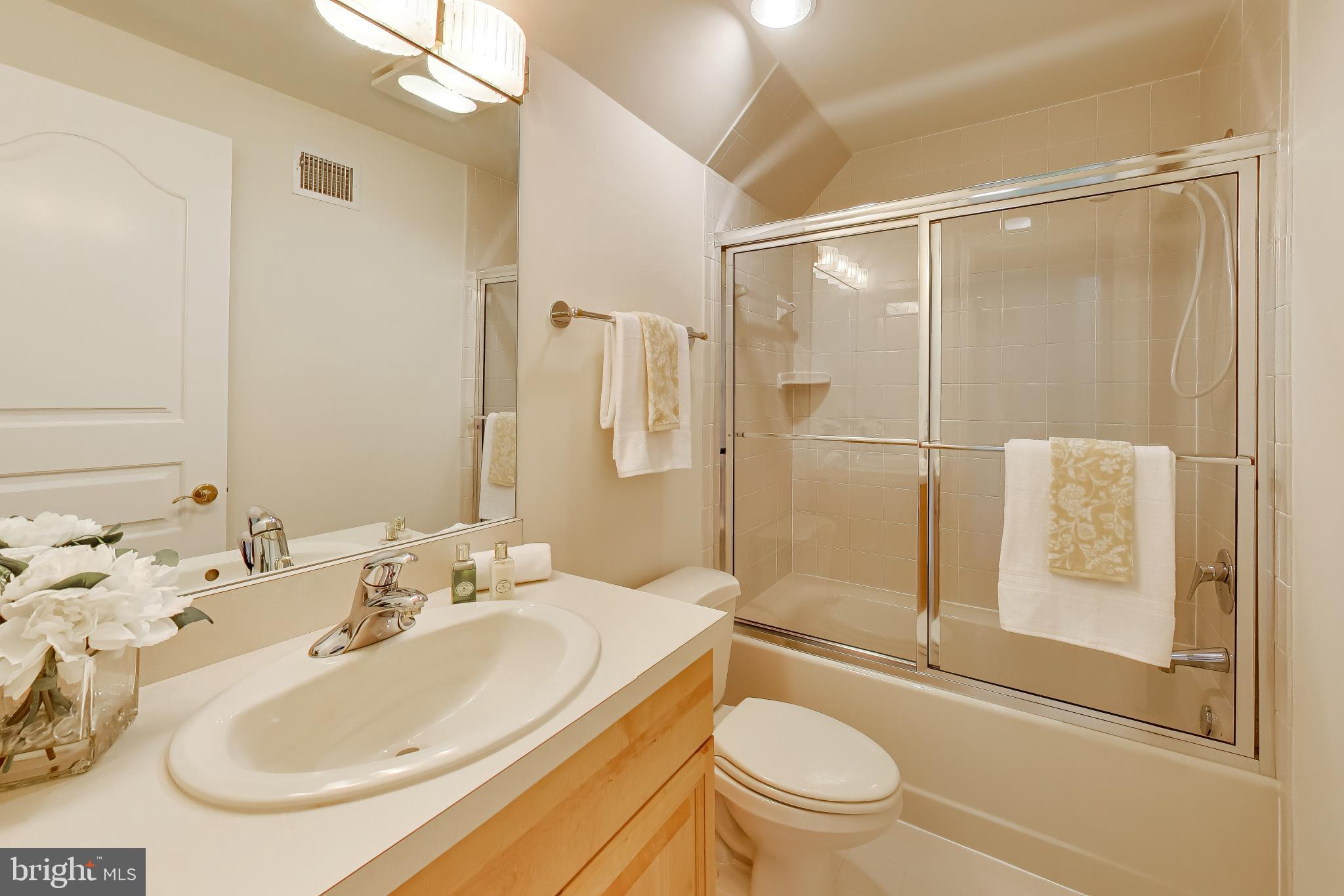 9001 Persimmon Tree Road Potomac, MD 20854 - Photo 51 of 77 a bathroom with a sink toilet and shower