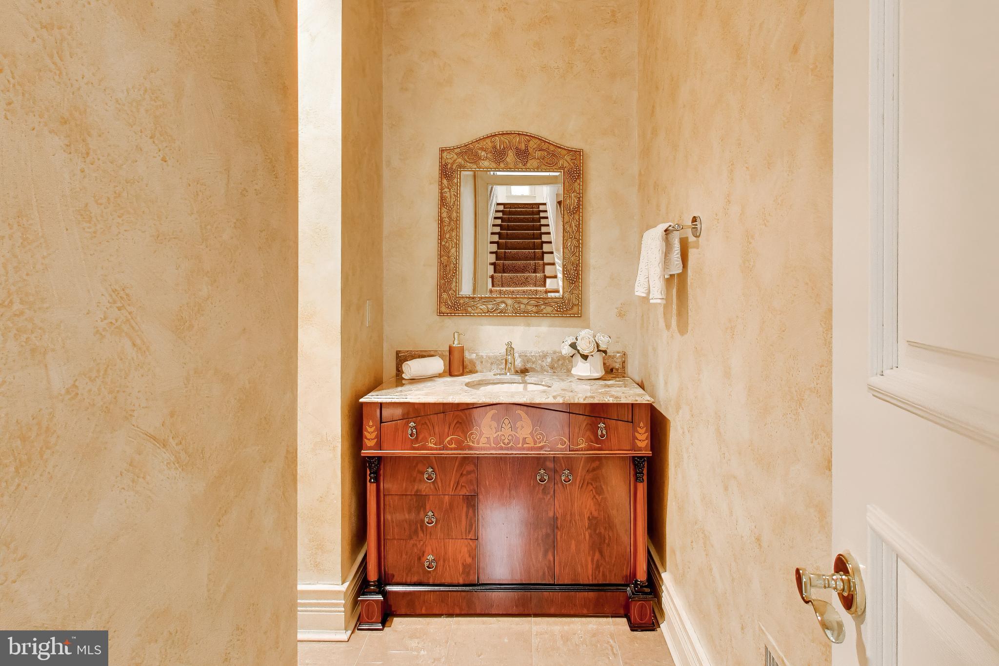 9001 Persimmon Tree Road Potomac, MD 20854 - Photo 60 of 77 a bathroom with a sink and a mirror