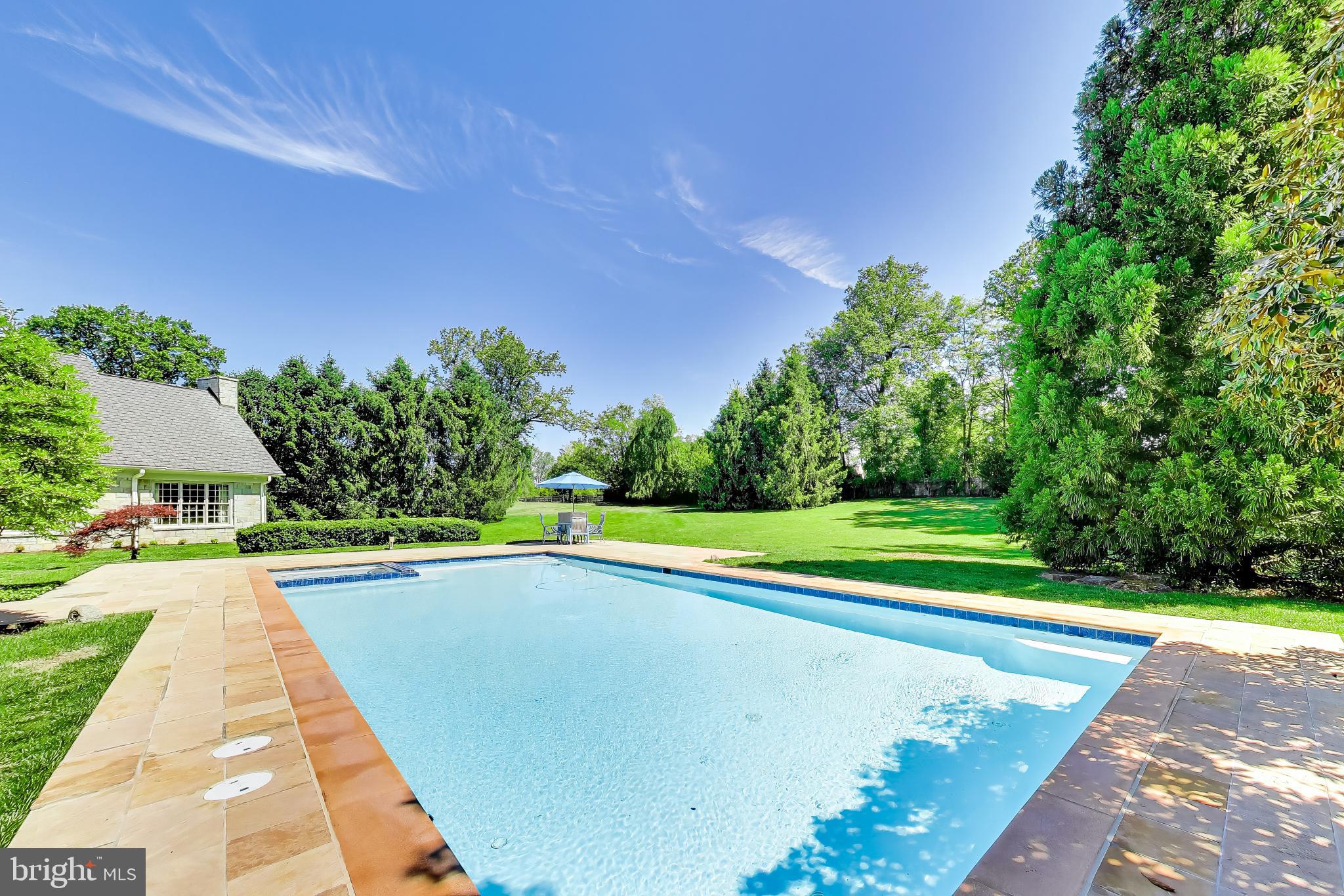 9001 Persimmon Tree Road Potomac, MD 20854 - Photo 71 of 77 a view of a swimming pool with a yard and plants