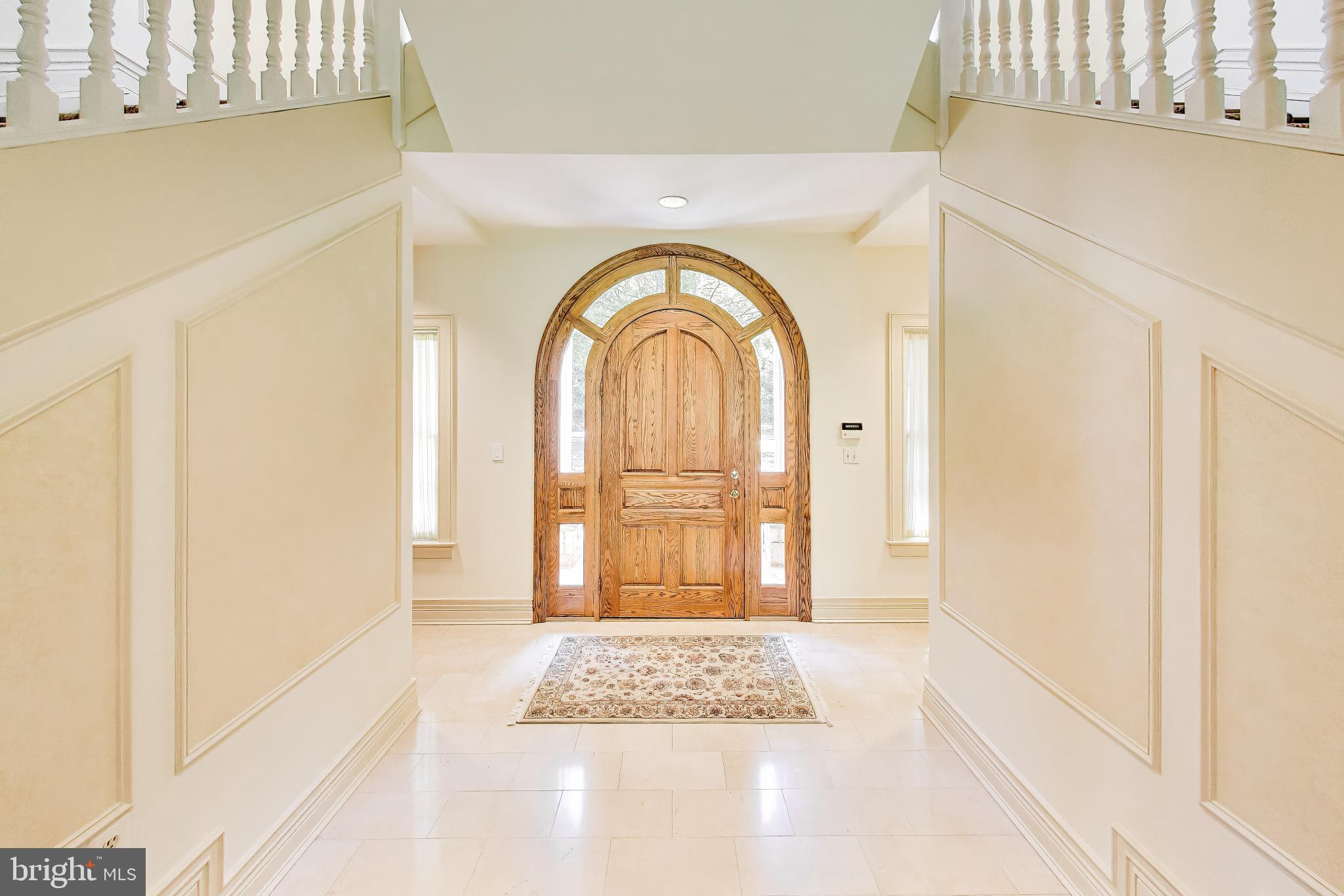 9001 Persimmon Tree Road Potomac, MD 20854 - Photo 8 of 77 a view of an entryway with a floor to ceiling window