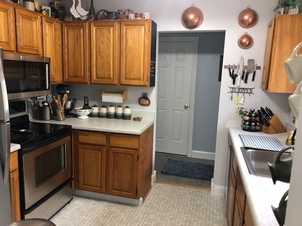 204 Beacon Park Road, Unit 204 Webster, MA 01570 - Photo 11 of 29 a kitchen with stainless steel appliances a stove a sink and a microwave