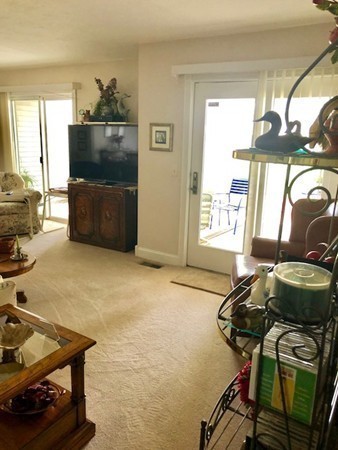 204 Beacon Park Road, Unit 204 Webster, MA 01570 - Photo 16 of 29 a living room with furniture and a flat screen tv