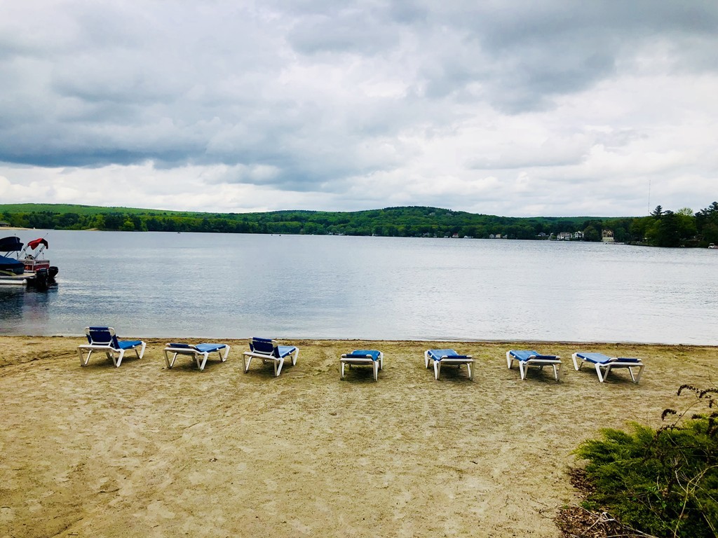 204 Beacon Park Road, Unit 204 Webster, MA 01570 - Photo 26 of 29 a view of a lake with houses in the back