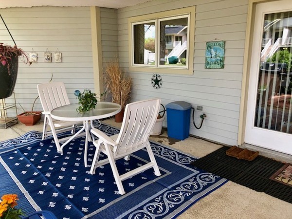 204 Beacon Park Road, Unit 204 Webster, MA 01570 - Photo 5 of 29 a view of a chairs and table in the patio