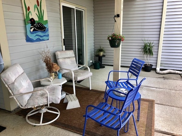 204 Beacon Park Road, Unit 204 Webster, MA 01570 - Photo 6 of 29 a view of a chairs and table in patio