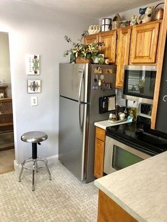 204 Beacon Park Road, Unit 204 Webster, MA 01570 - Photo 8 of 29 a kitchen with a refrigerator and a stove top open