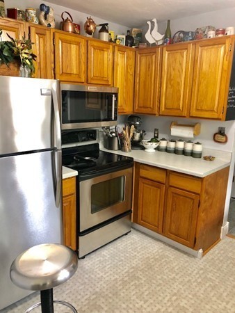 204 Beacon Park Road, Unit 204 Webster, MA 01570 - Photo 10 of 29 a kitchen with stainless steel appliances granite countertop a stove a sink and a refrigerator