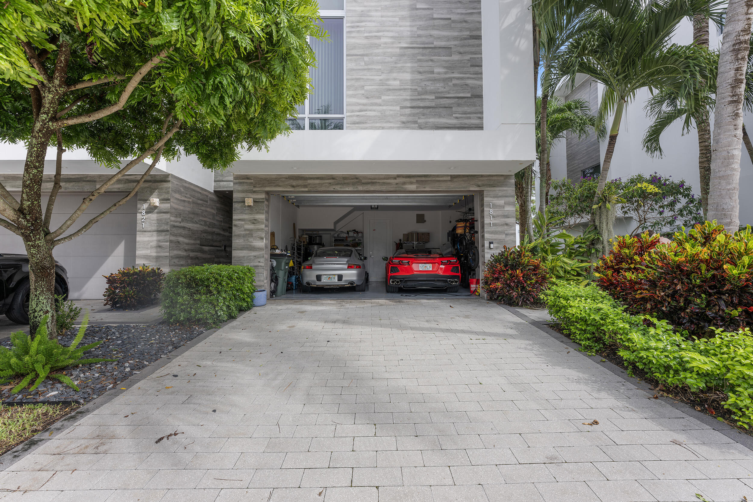 1811 Northwest 42nd Drive Boca Raton, FL 33431 - Photo 3 of 51 a car parked in front of yellow house with a small yard