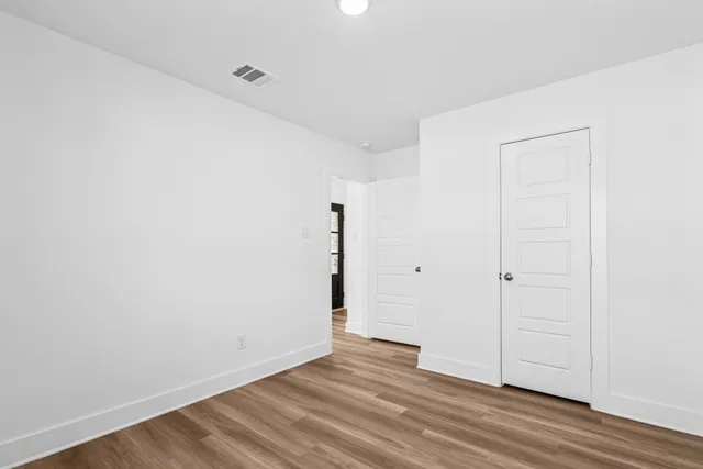 a view of a room with wooden floor