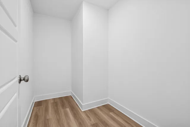 a view of kitchen with sink and refrigerator