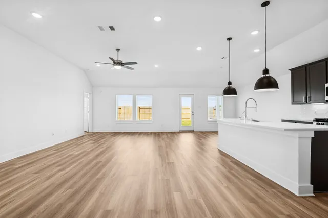 a view of a kitchen with a sink and a ceiling fan