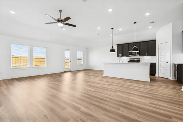 a view of kitchen with microwave oven a sink and white cabinets