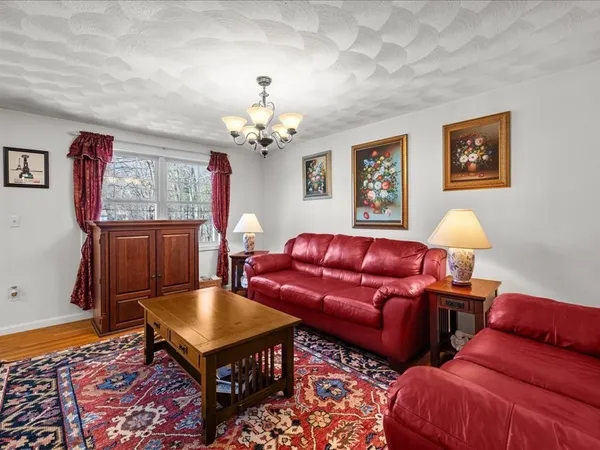 a view of a dining room with furniture chandelier and wooden floor