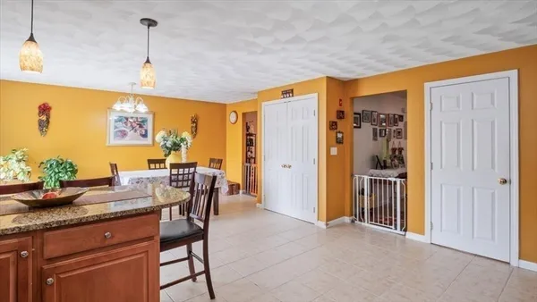 a view of a dining room with furniture and chandelier
