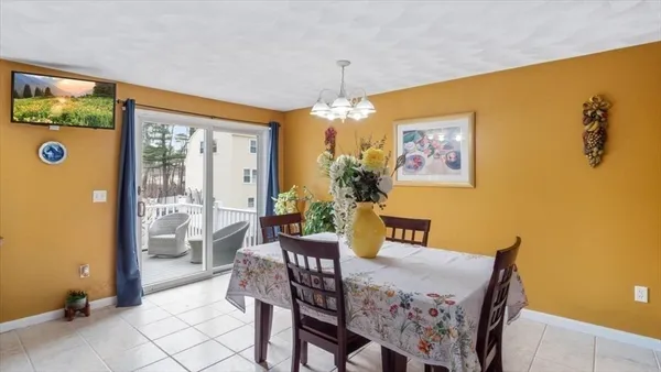 a view of a dining room with furniture and chandelier