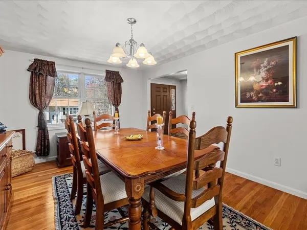 a view of a hallway view with wooden floor and furniture