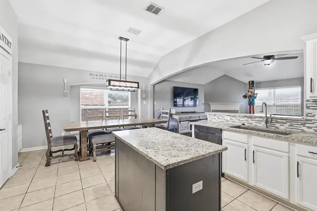 a kitchen with stainless steel appliances granite countertop a stove sink and refrigerator