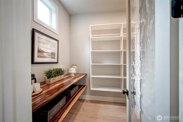 a bedroom with two beds and a large window