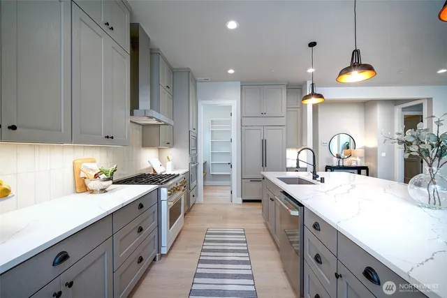 a dining room with furniture a chandelier and wooden floor